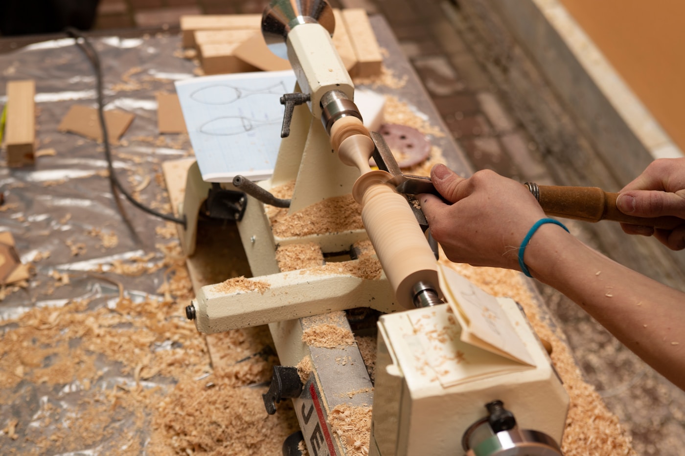 A wooden form mounted on a lathe before finishing