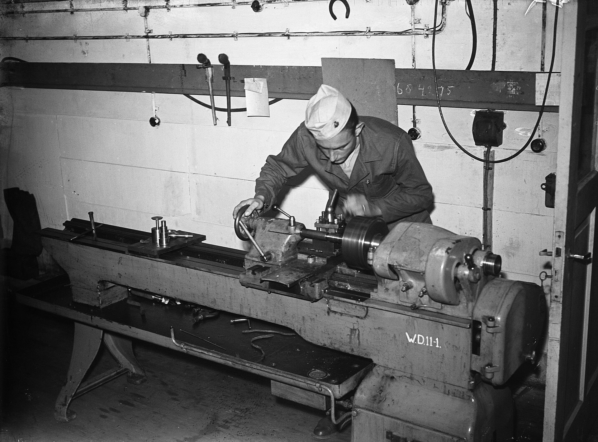 Historical photograph of a craftsman working at a wood lathe, Netherlands, from the Nationaal Archief