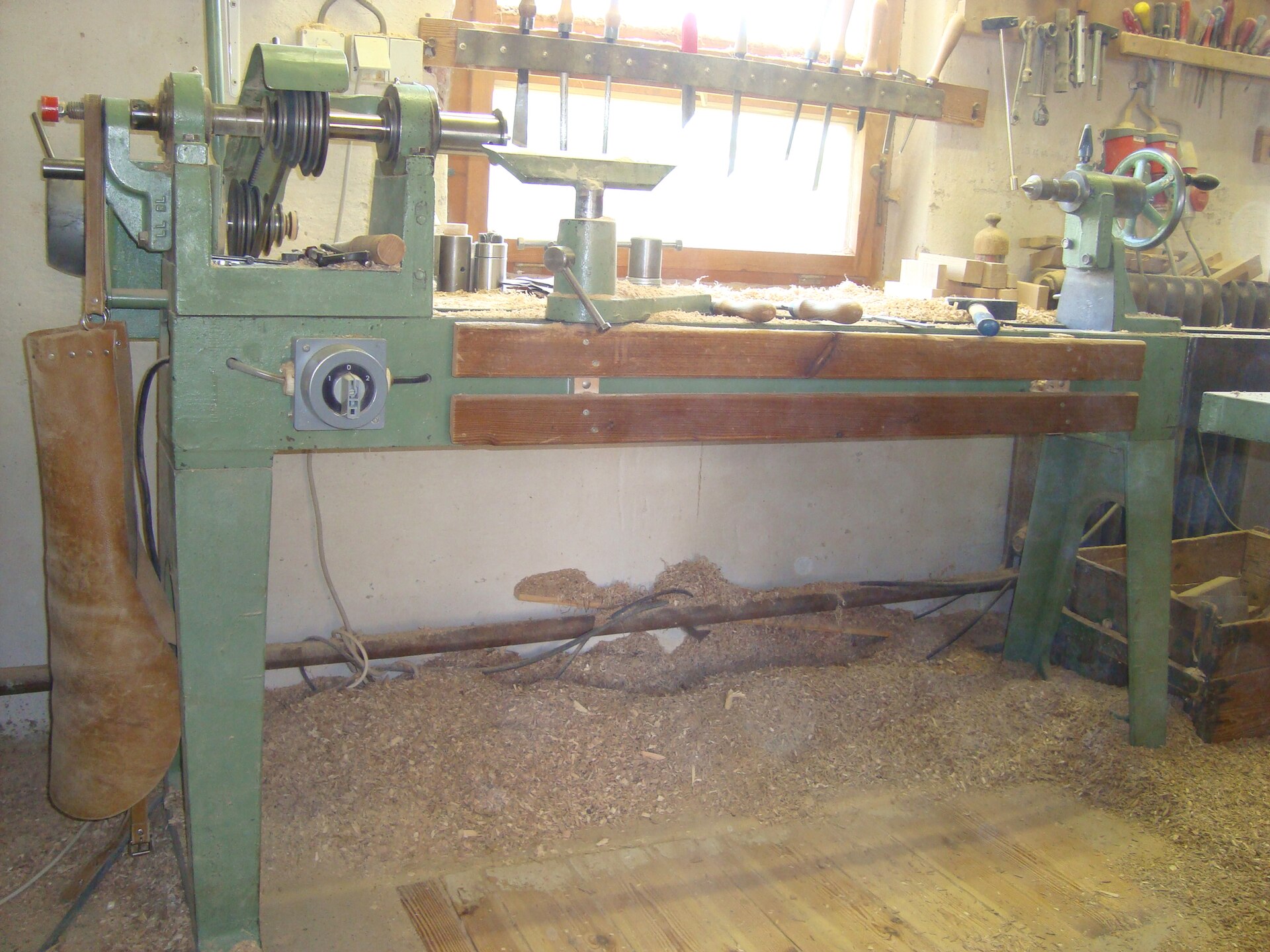 Traditional wood lathe (Holzdrehbank) in a workshop setting