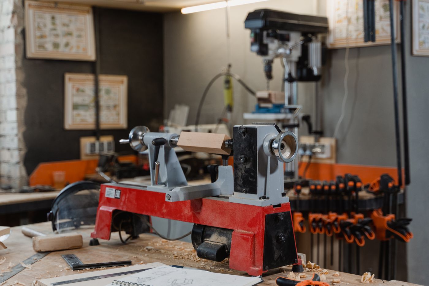 A craftsman using a wood lathe in a workshop, concentrating on shaping a piece