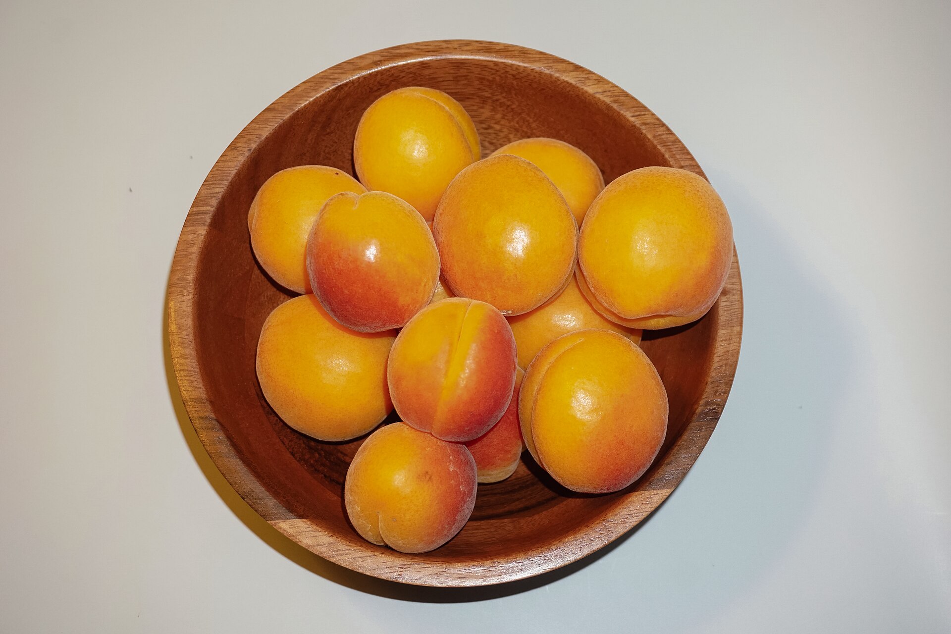 A turned wooden bowl holding fruit